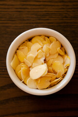 small bowl with filleted almonds close up
