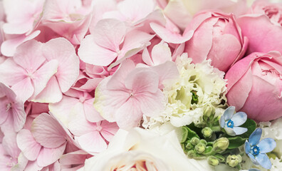 Beautiful flower bouquet arrangement close up in pastel colors. Decoration of hydrangea, roses and decorative plants