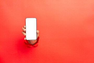 man hand holding a blank screen smart phone on Red background with clipping path