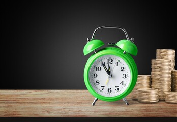money background, coins and alarm clock on the table, concept of bank deposits,