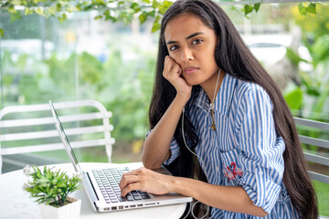 Young woman working outdoors with laptop