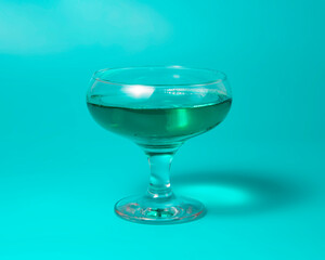 Green liqueur cocktail on color background with copy space