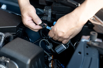 Close up hand a man hold plug of car headlight bulb Check for regularities and accuracy before...