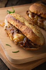 Pulled pork sandwich with melted cheese and BBQ sauce