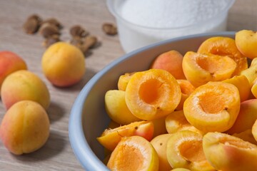 Apricot halves in a bowl, preparation for making preserves or jam