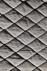background of gray fabric with rhombuses