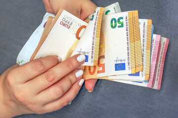 Woman hand with euro. Businesswoman hands hold and counting euro banknotes. Concept of corruption and bribery in Europe