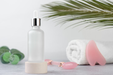 Obraz na płótnie Canvas SPA composition. White bottle with essential oil or serum on a podium. Massage set