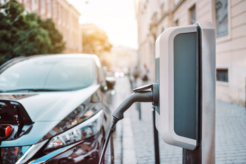 Charging modern electric car battery on the street