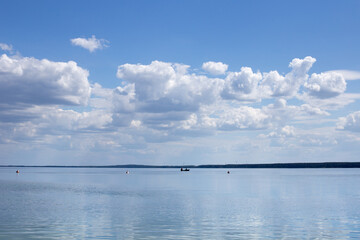 Reflection of white clouds in the mirror of clear water