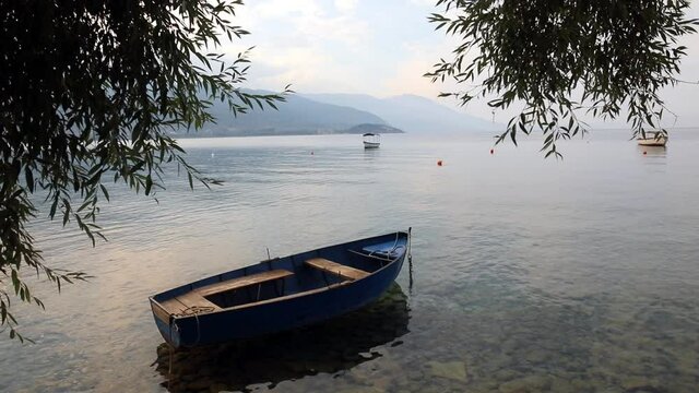 High angle HD footage of a empty wooden boat floating on water.