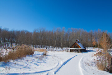 Old barn in a winter countryside landscape in Quebec, Canada