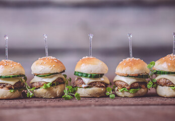 Close up of mini beef burgers isolated on wood background