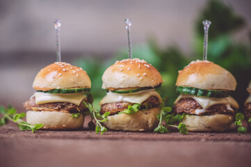 Close up of mini beef burgers isolated on wood background