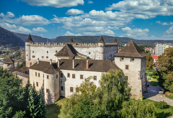 Fototapeta na wymiar Aerial panorama view of Zvolen medieval castle with turrets and gate house, outer castle buildings in Slovakia blue cloudy sky background