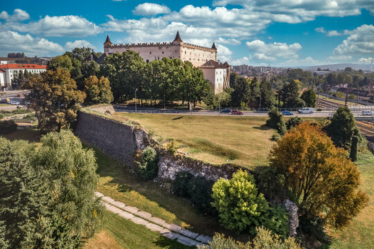 Aerial panorama view of Zvolen medieval castle with turrets and outer bastion fortification in Slovakia blue cloudy sky background
