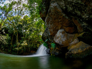 Long exposure view of a small waterfall hidden in a forest located in the north of Mauritius island