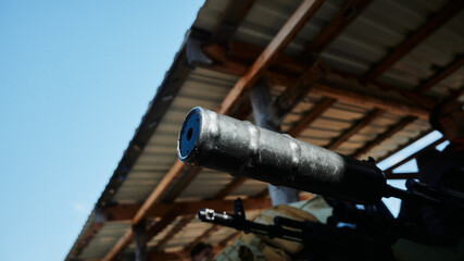 Silencer on a Kalashnikov assault rifle against the background of a Kalashnikov assault rifle