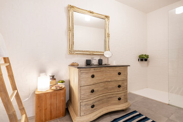 Toilet decorated with stripped furniture and matching square mirror with black marble sink
