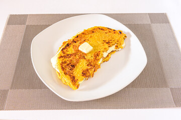 Cachapa is a typical corn-based dish stuffed with fresh cheese on a white plate