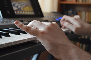 Close up of blind man hands playing the piano
