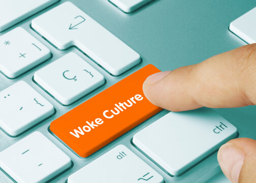 Woke culture - Inscription on Orange Keyboard Key.