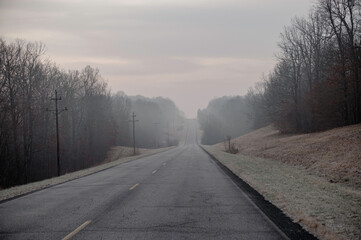 Foggy gloomy country road on an overcast day. 