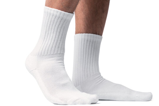Male feet with white cotton socks on white background