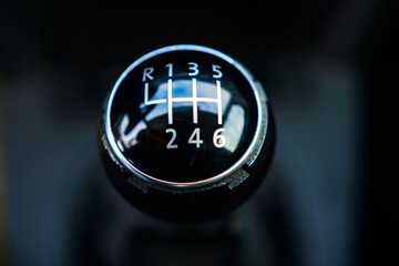 Mechanical gear lever close up. A car with a six speed transmission.