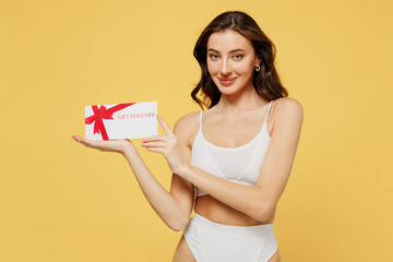Smiling happy caucasian young brunette woman 20s in white underwear with perfect fit body hold gift...