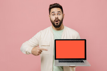 Young smiling happy man 20s in trendy jacket shirt hold use work point on laptop pc computer with...