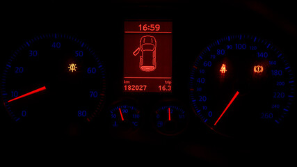 car speedometer and tachometer at night