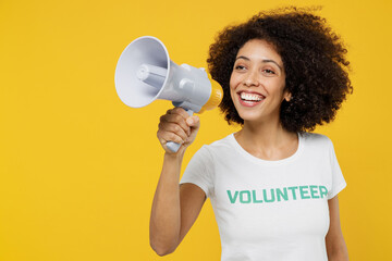 Young woman of African American ethnicity wear white volunteer t-shirt hold scream in megaphone hot...