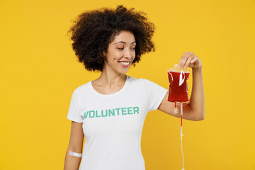 Young cool smiling happy donor woman of African American ethnicity wears white volunteer t-shirt...