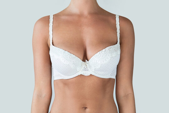 Woman with natural breast wearing white bra