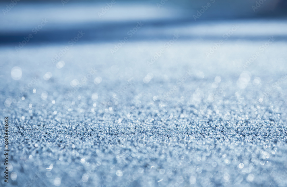 Poster defocused sunlight through frosty patterns on the road in winter, selective focus bokeh reflection o