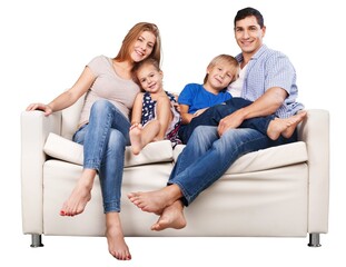 Happy family sitting on the sofa smiling at camera