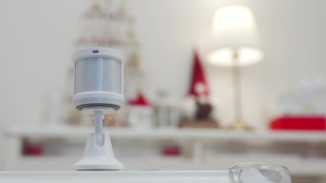 Motion sensor for smart home used to monitor an area and control smart lights. Motion detector turn on off the light in the room. High quality 4k footage
