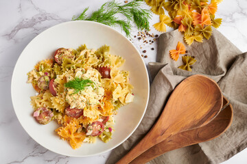 Freshly home made creamy bow tie pasta salad with dill and black pepper. 