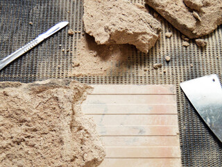 Cleaning the back of old tiles. Removing the mortar from a tile with a spatula. Professional conservator active in the restoration and conservation of old ceramic tiles. 