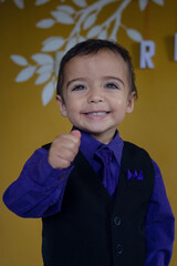 portrait of elegant little boy making nice gestures