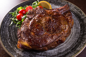 detail of steak on plate over wooden table