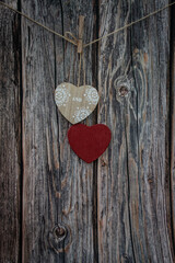Moscow, Russia, January 2022 Valentine's Day card, two wooden hearts hanging on a twine on a wooden background