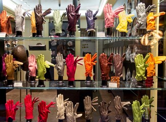 Fototapeta na wymiar Multi-colored hand gloves wave from a Venitian shop window.