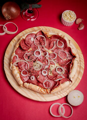 pizza with salami and tomatoes