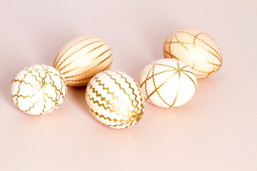 Easter eggs on a light background, beautiful golden stripes, delicate decor, Easter.
