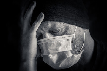 A man in a protective mask against coronavirus, close-up. Viral infection, Covid-19 (SARS-CoV-2)...