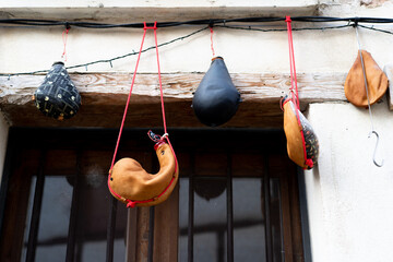 Handcrafted wineskin hanging on the facade of a wineskin shop