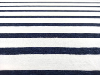 Fototapeta premium Blue and white striped cotton fabric background. Horizontal striped cotton texture perspective view.