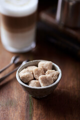 Brown sugar cubes in a small ceramic dish. Close up.	